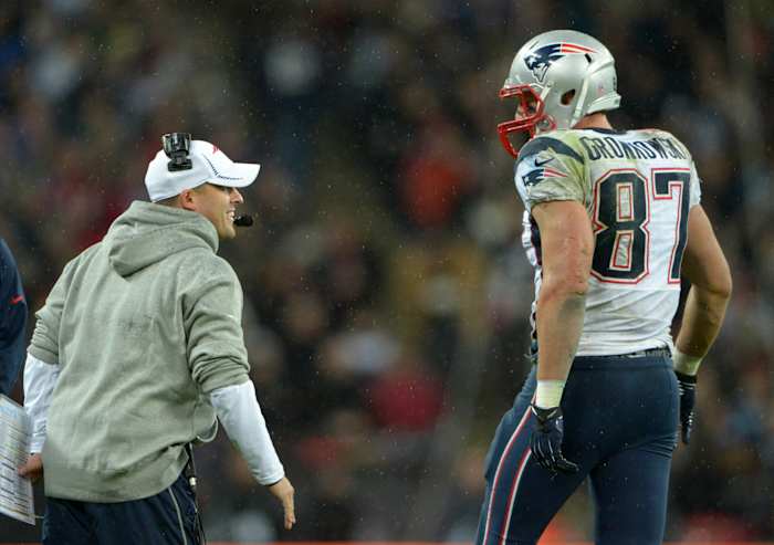 Oct 28,2012; London, UNITED KINGDOM; New England Patriots tight end Rob Gronkowski (87) is congratulated by offensive coordinator Josh McDaniels after scoring on a 14-yard touchdown pass in the fourth quarter against the St. Louis Rams in the 2012 NFL International Series game at Wembley Stadium. The Patriots defeated the Rams 45-7.